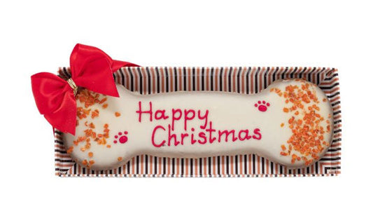 Dog bone-shaped treat with 'Happy Christmas' text and red bow on a white background